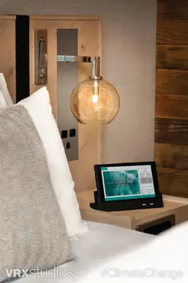 a laptop computer sitting on a table next to a bed at Seaside Hotel North Vancouver in North Vancouver