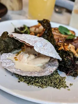 a plate of food with a shell on a table at Seaside Hotel North Vancouver in North Vancouver