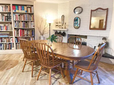a dining room with a wooden table and chairs at Wisteria Guest House in Ganges