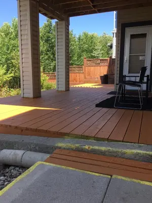 a porch with a deck with a chair on it at 民宿Ann's House in Calgary in Calgary