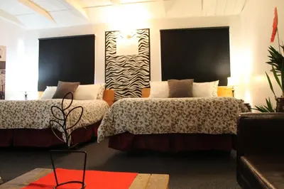 a hotel room with two beds and a couch at Sage Hills Motel in Cache Creek