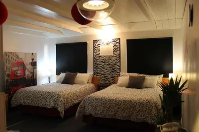 a bedroom with two beds and a ceiling at Sage Hills Motel in Cache Creek