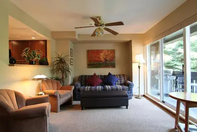 a living room with a couch and a ceiling fan at Lagoons Condos by Whistler Retreats in Whistler