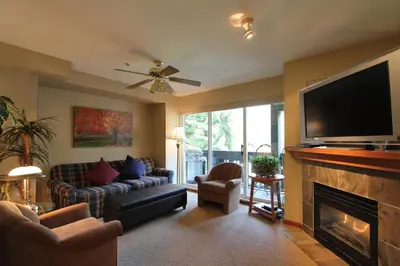 a living room with a television and a fireplace at Lagoons Condos by Whistler Retreats in Whistler