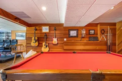 a pool table in a room with guitars on the wall at The Blue House Bed and Breakfast in Lake Country