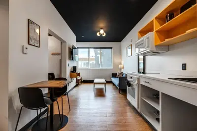 a kitchen and dining room with a table and chairs at Raven Inn Whitehorse in Whitehorse