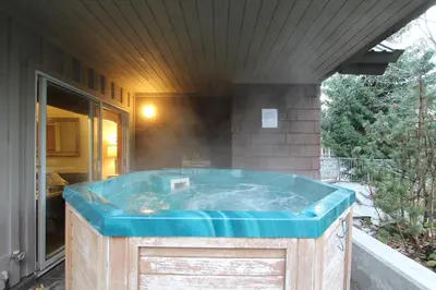 a jacuzzi tub in the backyard of a house at Glacier's Reach by Whistler Retreats in Whistler