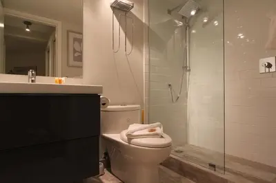 a bathroom with a toilet and a glass shower at Glacier's Reach by Whistler Retreats in Whistler