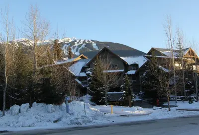 a lodge in the snow with a mountain in the background at Glacier's Reach by Whistler Retreats in Whistler