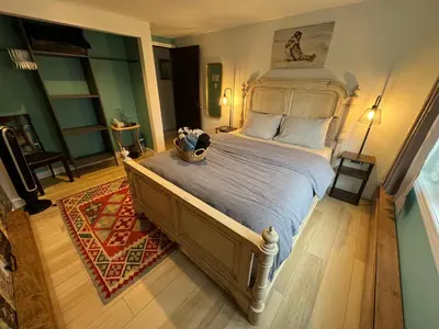 a bedroom with a large bed with a teddy bear on it at \u597d\u4e18\u3002Hacho House in Yellowknife