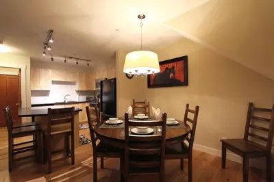 a kitchen and dining room with a table and chairs at Villas Snowberry by Whistler Retreats in Whistler