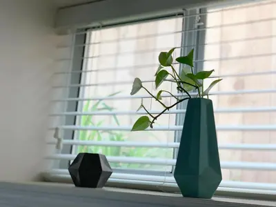 a green vase sitting on a window sill with a plant at Perfect Location - Entire Suite Private Entrance with private bathroom & living room - 5 Mins Walk to Skytrain & Restaurant & Banks, 2 Stops To Metrotown, 5 Stops To Downtown in Vancouver