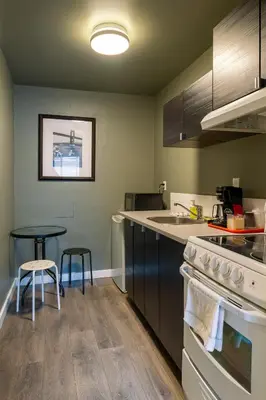 a kitchen with a sink and a stove top oven at Ace Motel in Princeton