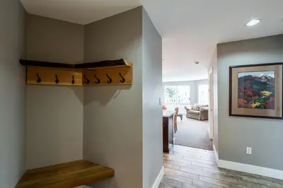 a hallway with a staircase in a house at Whistler Blackcomb Vacation Rentals - Village North in Whistler