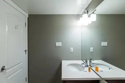 a bathroom with a sink and a mirror at Whistler Blackcomb Vacation Rentals - Village North in Whistler