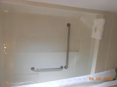 a bathroom with a tub and a towel rack at Mountain Springs Motel & RV Park in Barrière