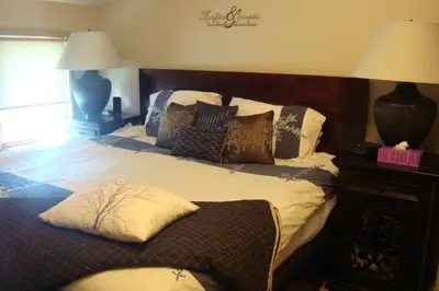 a bedroom with a large bed with pillows on it at YPC Fitness & Accomodations in Invermere
