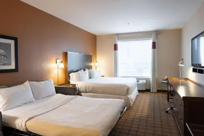 a hotel room with two beds and a large window at Four Points by Sheraton Edmonton International Airport in Nisku
