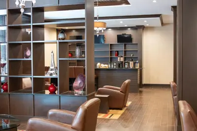 a lobby with chairs and a waiting room at Four Points by Sheraton Edmonton International Airport in Nisku