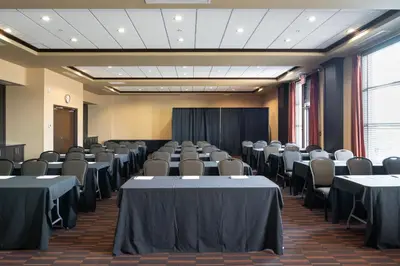 a room with rows of tables and chairs at Four Points by Sheraton Edmonton International Airport in Nisku