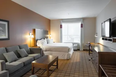 a hotel room with a bed and a couch at Four Points by Sheraton Edmonton International Airport in Nisku