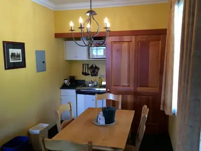 a kitchen with a wooden table and a dining room at Park Place Lodge in Fernie