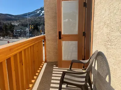 a bench sitting on the porch of a house at Park Place Lodge in Fernie