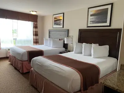 a hotel room with two beds and a window at Ramada by Wyndham Creston in Creston
