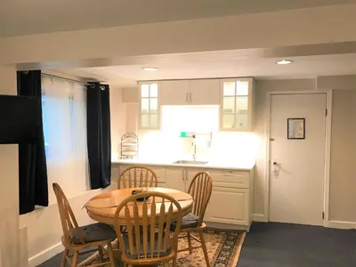 a kitchen and dining room with a table and chairs at Cambie Lodge in Vancouver