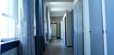 a hallway with blue walls and a window in a hospital at HI Vancouver Jericho Beach - Hostel in Vancouver