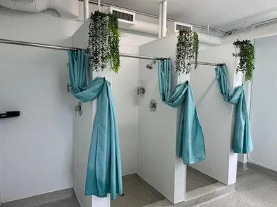 a room with blue curtains and plants on a wall at HI Vancouver Jericho Beach - Hostel in Vancouver