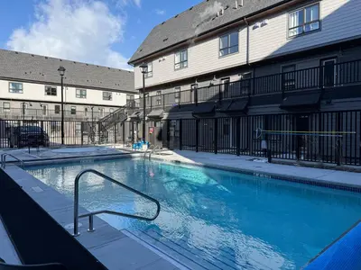 a large swimming pool in front of a building at Joe's Contemporary 2 King Bedrooms Vacation Home in Canmore in Canmore