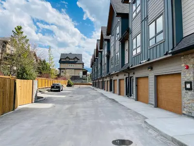 an empty street with a car parked next to a building at Joe's Contemporary 2 King Bedrooms Vacation Home in Canmore in Canmore