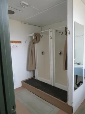 a bathroom with a shower and a sink at Barney’s Lakeside Resort in Puntzi Lake