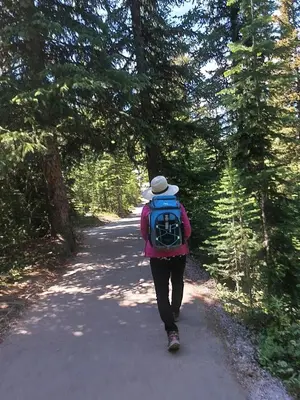 a person with a backpack walking down a road at Green Village in Calgary