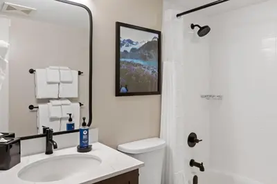 a bathroom with a sink and a toilet and a mirror at Worldmark Whistler Sundance in Whistler