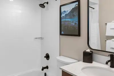 a bathroom with a sink and a tub and a mirror at Worldmark Whistler Sundance in Whistler