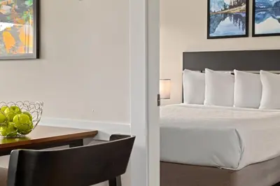 a bedroom with a bed and a table with a bowl of fruit at Worldmark Whistler Sundance in Whistler