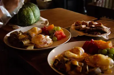 three plates of food on a wooden table at The Fraser River's Edge B&B Lodge in Chilliwack