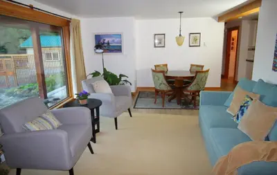 a living room with chairs and a table and a dining room at Mossy Hill Suite in Salt Spring Island