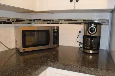 a microwave sitting on top of a counter in a kitchen at Mossy Hill Suite in Salt Spring Island