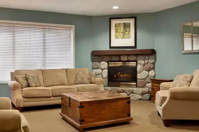 a living room with a couch and a fireplace at Travelodge by Wyndham Edson in Edson