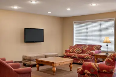 a living room with a couch and a tv at Travelodge by Wyndham Edson in Edson