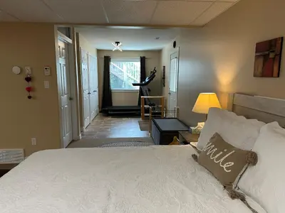 a bedroom with a large bed and a hallway at 1st Choice Bed and Breakfast in Whitehorse