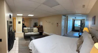 a bedroom with a bed and a living room at 1st Choice Bed and Breakfast in Whitehorse