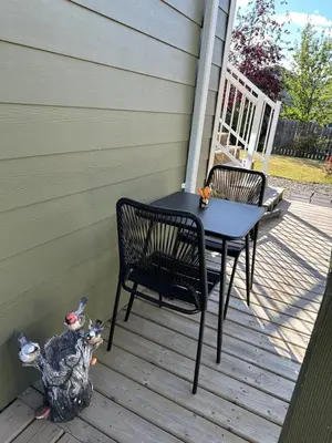 a table and chairs on a porch with a turkey at 1st Choice Bed and Breakfast in Whitehorse