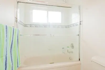 a white bathroom with a tub and a shower at Harmony House in Richmond