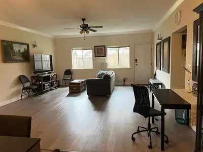 a living room with a couch and a ceiling fan at V.I.P. CLUB in Surrey