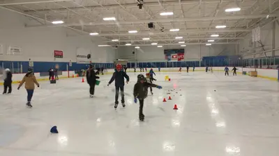 a group of people skating on an ice rink at Hannah's Heavenly Home in Surrey