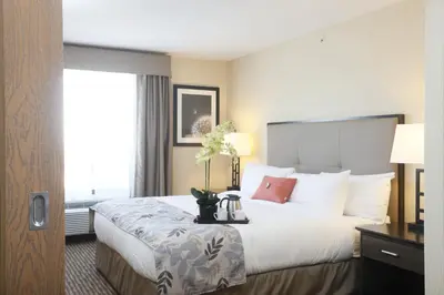 a hotel room with a large bed and a window at Pomeroy Inn & Suites at Olds College in Olds